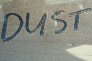 The word 'DUST' written on car rear windscreen following Saharan sand deposited in England by strong south easterly winds